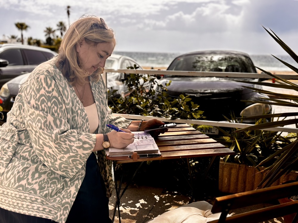 Jeanna Park planning a client's coaching route by the coast in Mojácar